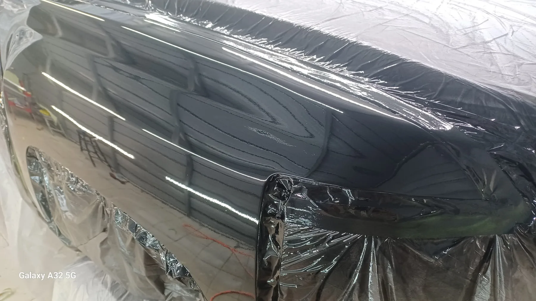 Masked classic car panel prepared for paint and body training