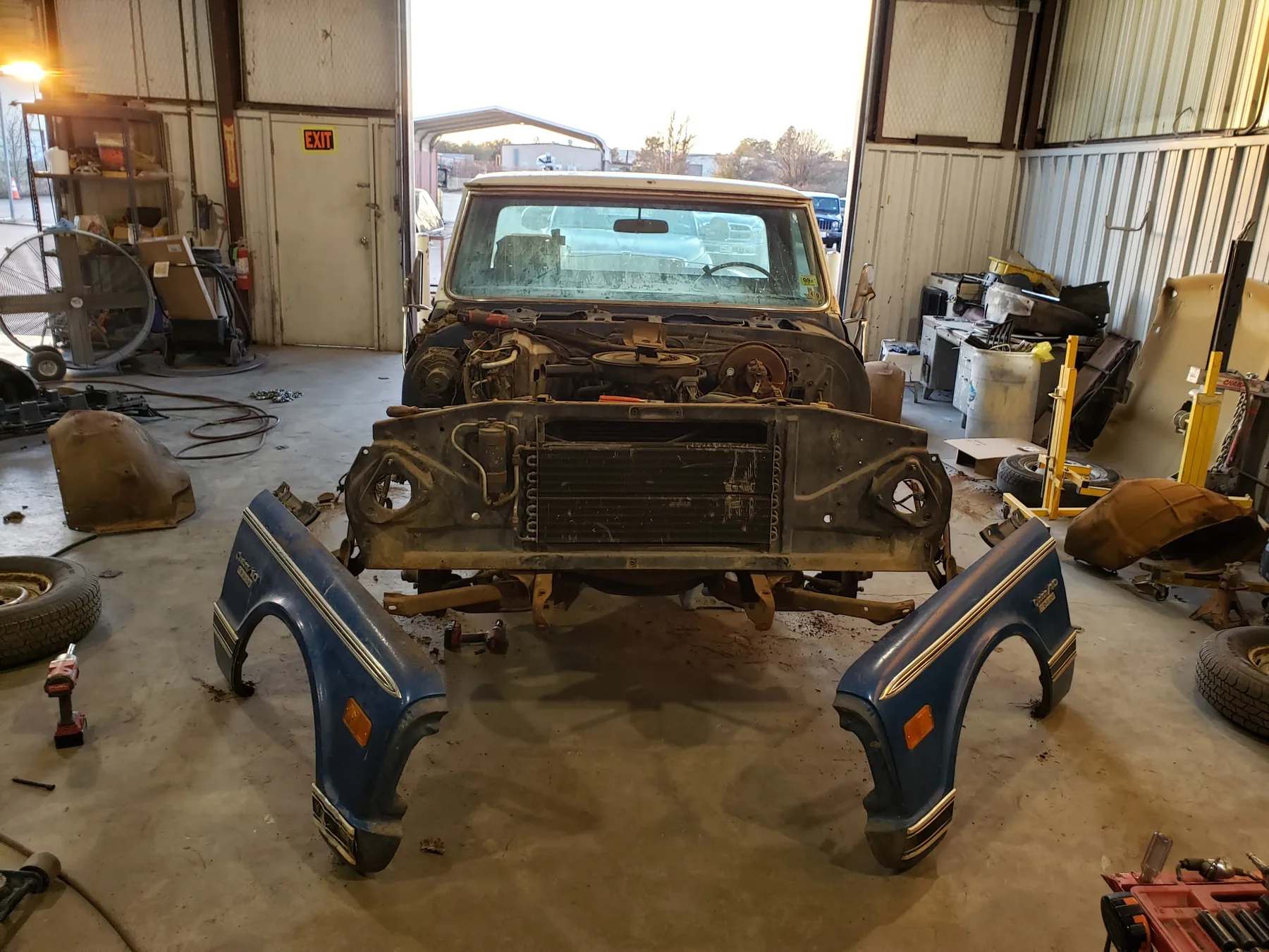 Blue truck front clip disassembly during Red Barn repair process
