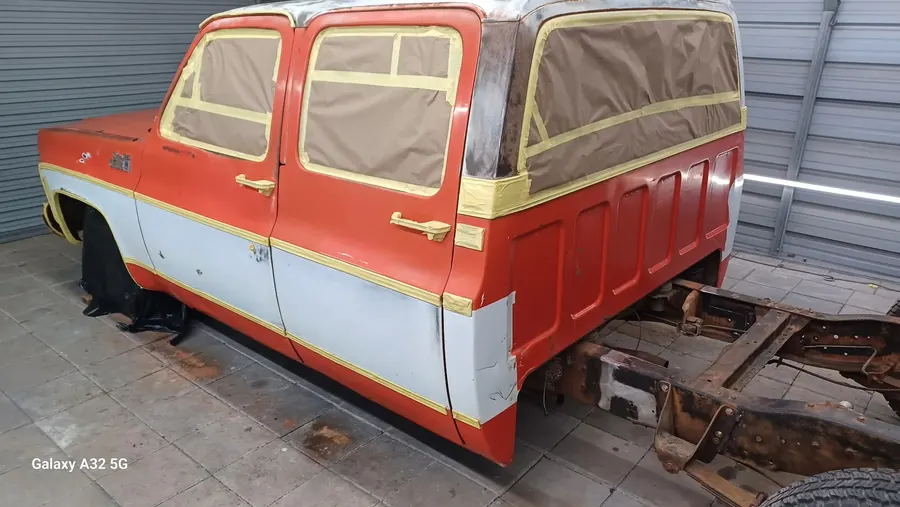 Orange and white classic truck side masked for work