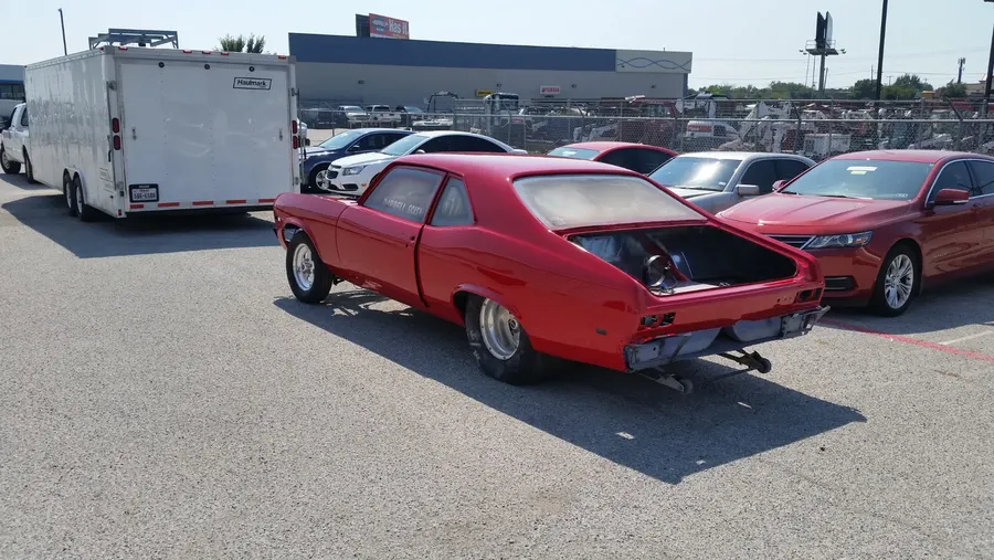 Red classic car at car show rear view