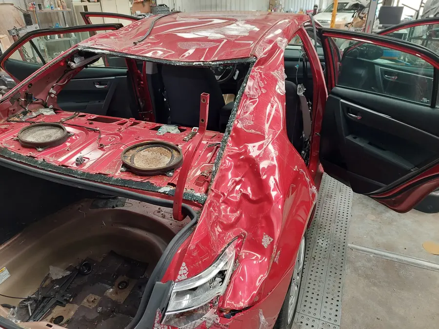 Red sedan roof teardown stage