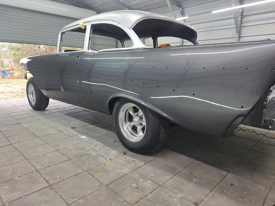 Tri-five Chevy side body work in gray primer