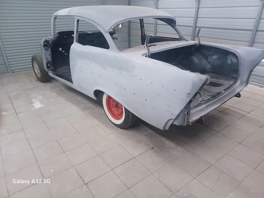 Tri-five Chevy body in primer with trunk open