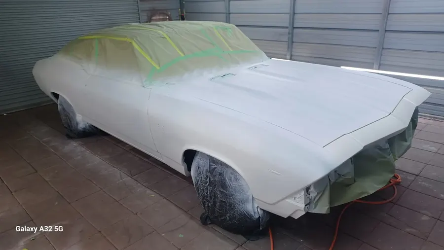 White primer classic car in booth