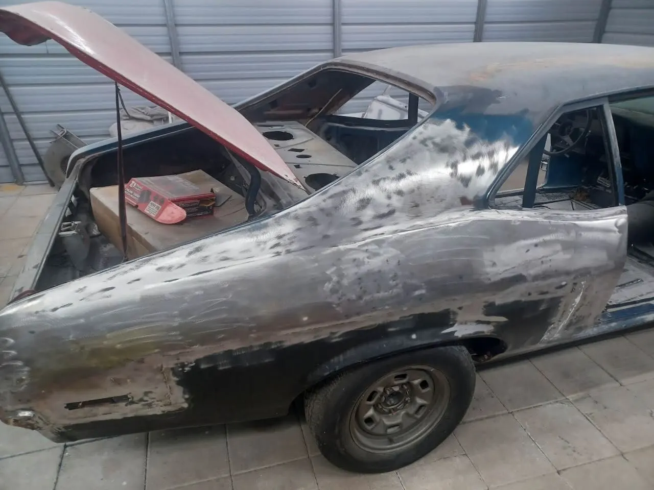 Vehicle in the Red Barn shop with the hood up